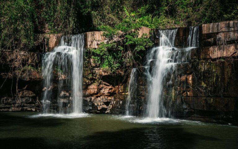 gratitud diaria, A serene waterfall cascading over rocks in the lush forest of Thailand.